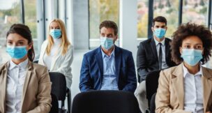 Seated audience wearing masks at event